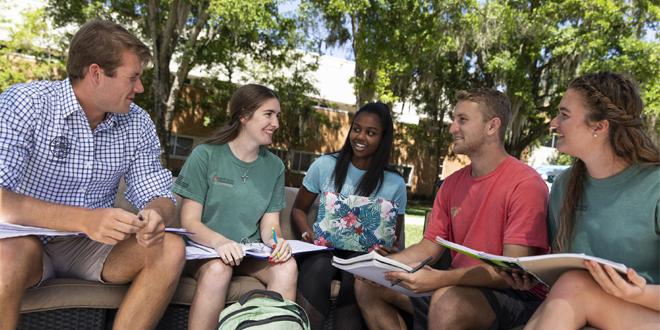 five students studying outside 